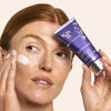 Model holding tube of Yon-Ka Paris Elastine Jour (50 ml) and applying smear to cheek