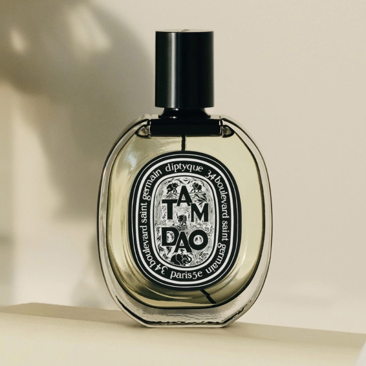 Diptyque Tam Dao Eau de Parfum spray (75 ml) - product shown on creme background. 