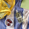 Lifestyle shot top view of Laboratory Perfumes Samphire Eau de Toilette on blue and white stripe tablecloth