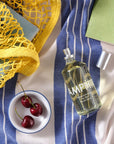Lifestyle shot top view of Laboratory Perfumes Samphire Eau de Toilette on blue and white stripe tablecloth
