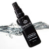 Odacite Aloe Immortelle Hydra-Repair Treatment Mist (1.69 oz) partially submerged in water