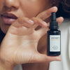 Vintner's Daughter Active Botanical Serum (30 ml) - model shown holding product