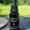 Lifestyle shot of de Mamiel Summer Facial Oil (20 ml) on table top outside