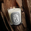  Diptyque Oud Candle (190 g) - product shown on top of wood. 