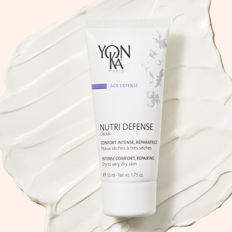 Yon-Ka Paris Nutri Defense Creme (50 ml) shown top view with large product smear in the background to show color and texture
