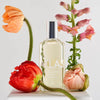 Lifestyle shot of Laboratory Perfumes Atlas Eau de Toilette with poppies and flowers in the foreground and background