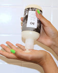 R+Co Bel Air Smoothing Shampoo - model holding bottle