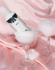R+Co Chiffon Styling Mousse - Lifestyle photo of product bottle in glasses
