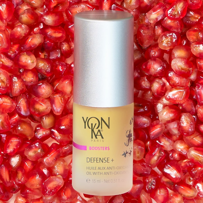 Yon-Ka Paris Defense + Oil with Anti-Oxidants (15 ml) shown top view with pomegranate seeds in the background