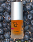 Yon-Ka Paris Hydra + Oil Hydrating Solution (15 ml) shown top view with blueberries in the background