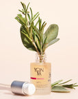 Yon-Ka Paris Lift + Firming Solution (15 ml) shown with top off and ingredients including rosemary and sage placed in bottle