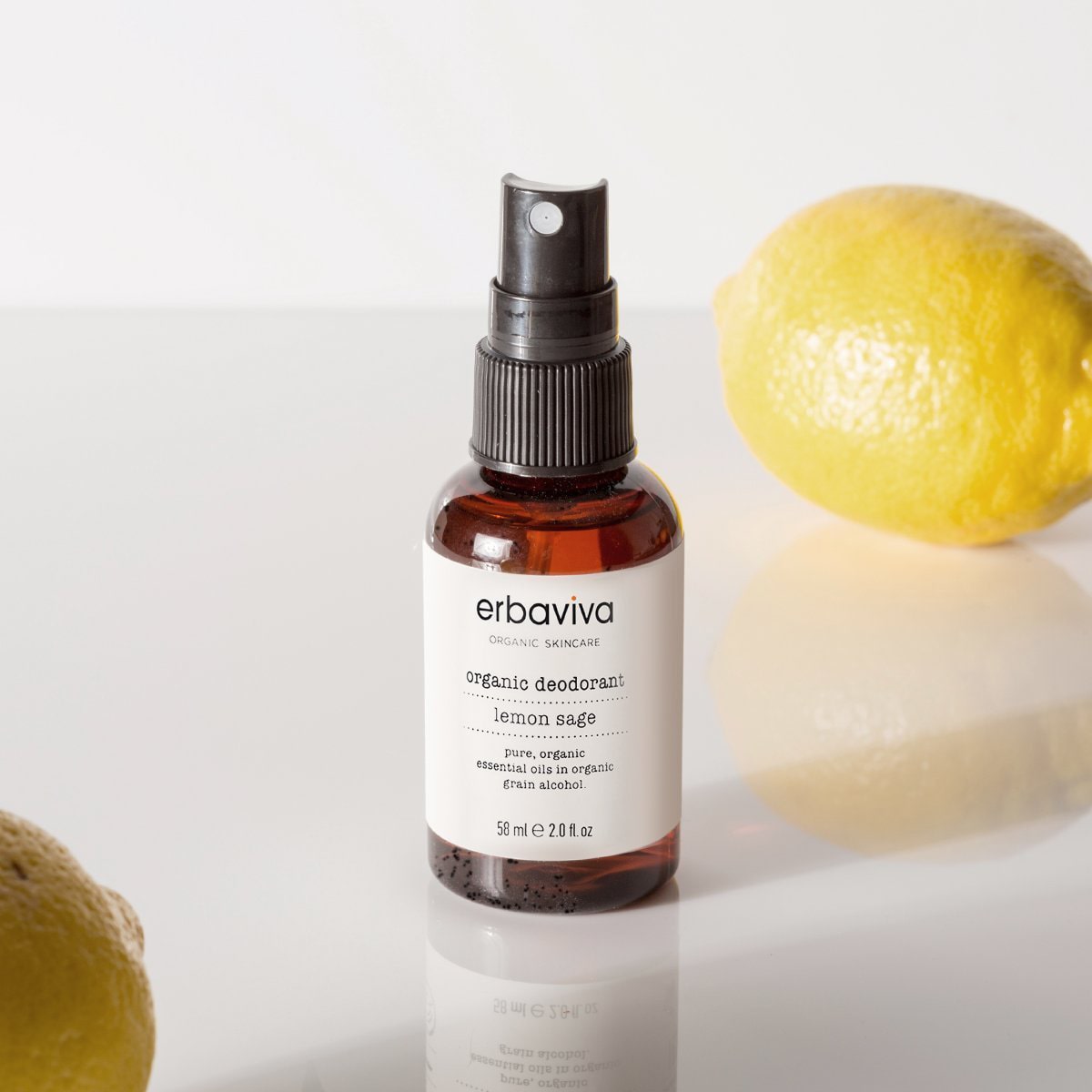 Lifestyle shot of Erbaviva Lemon &amp; Sage Organic Deodorant (2 oz) with lemons in the foreground and background