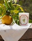 Lifestyle shot of Carriere Freres Siracusa Lemon Candle  (185 g) with lemon in the background
