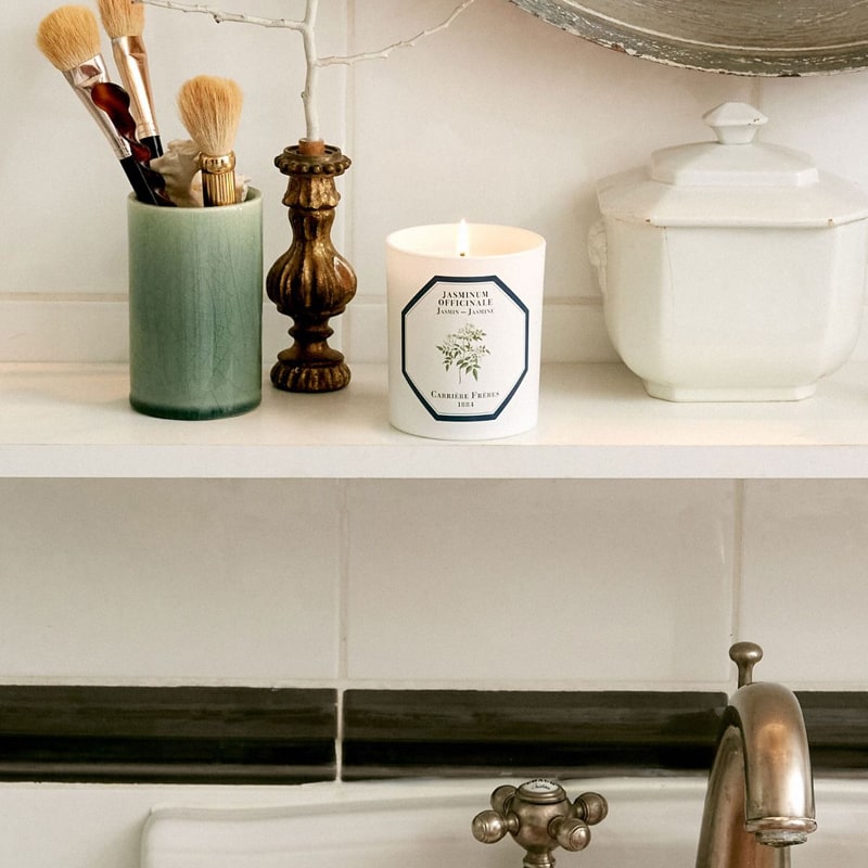Lifestyle shot of Carriere Freres Jasmine Candle (185 g) shown lit on shelf above bathroom sink
