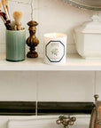 Lifestyle shot of Carriere Freres Jasmine Candle (185 g) shown lit on shelf above bathroom sink