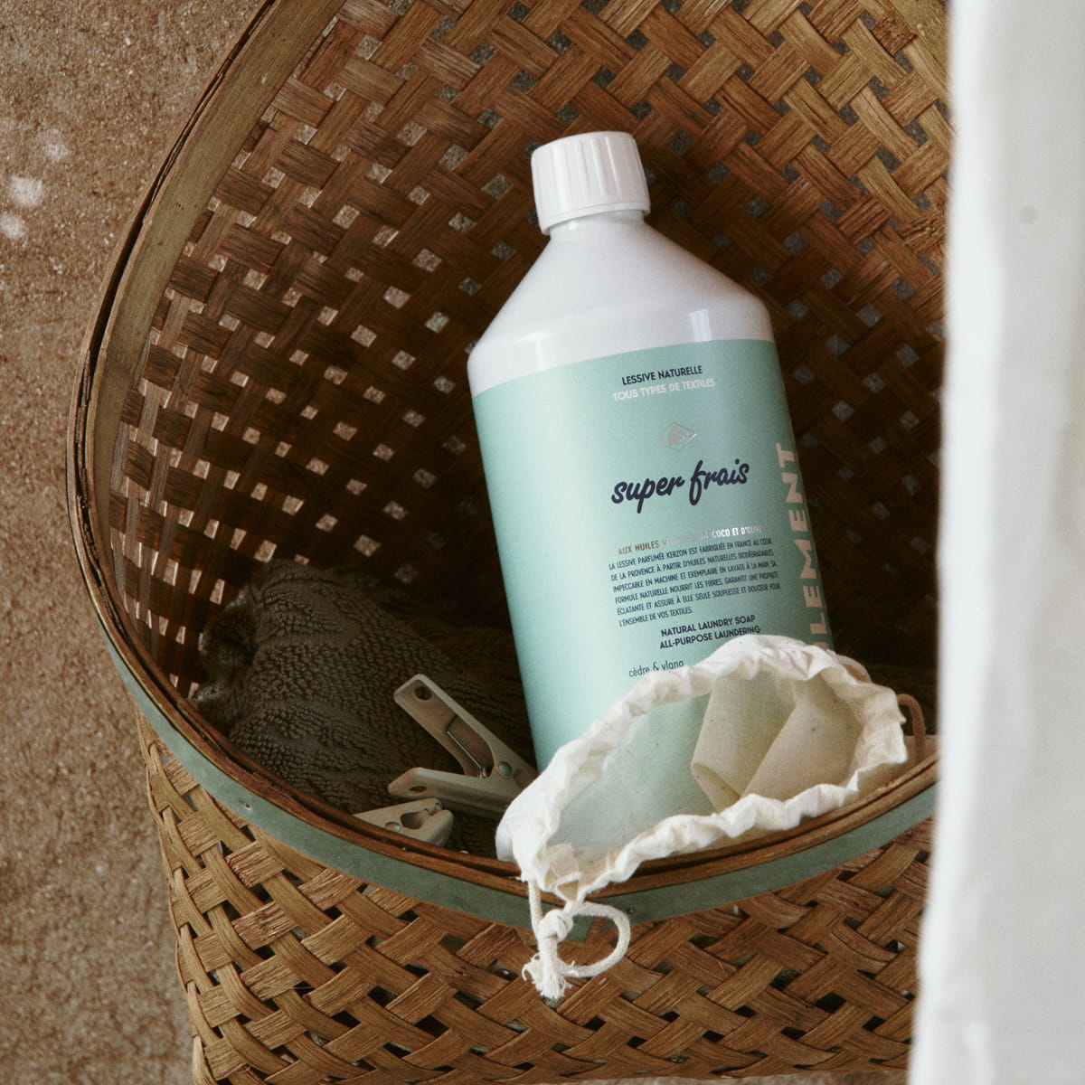 Kerzon Fragranced Laundry Soap - Super Frais (1 L) - product shown in basket with linens. 
