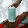 Kerzon Fragranced Laundry Soap - Super Frais (1 L) - product shown being held over linen basket. 