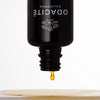 Odacite All-Embracing Hydrating Serum - product shown with serum dripping out