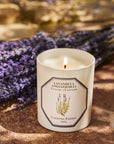 Lifestyle shot of Carriere Freres Lavender Candle (185 g) shown lit with lavender bunch in the background