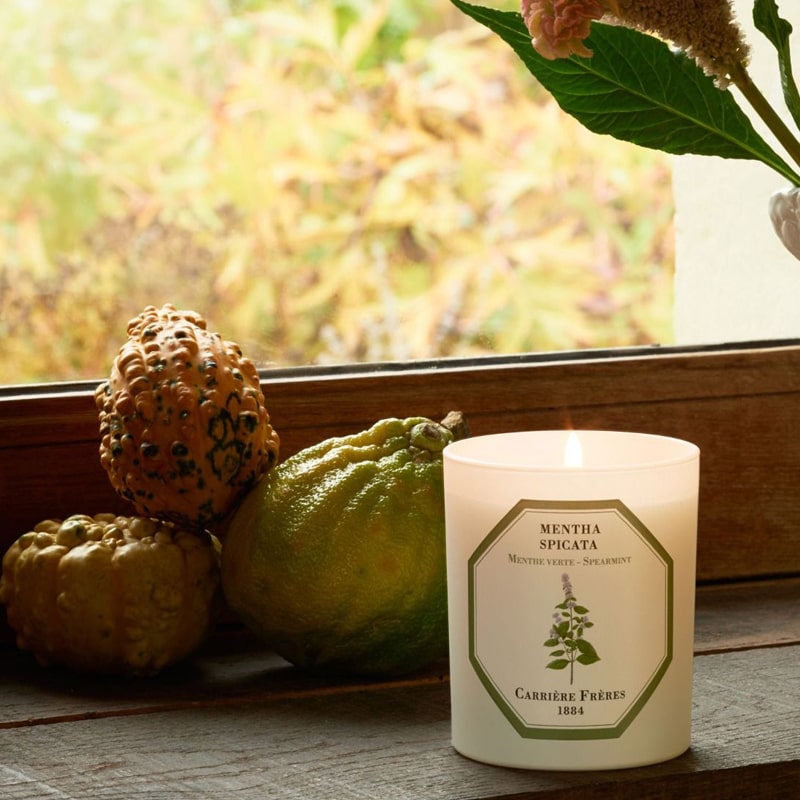 Lifestyle shot of Carriere Freres Spearmint Candle (185 g) shown lit on window sill