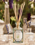 Lifestyle shot of Carriere Freres Lavender Diffuser (200 ml) with empty jars in the foreground with sprigs of lavender