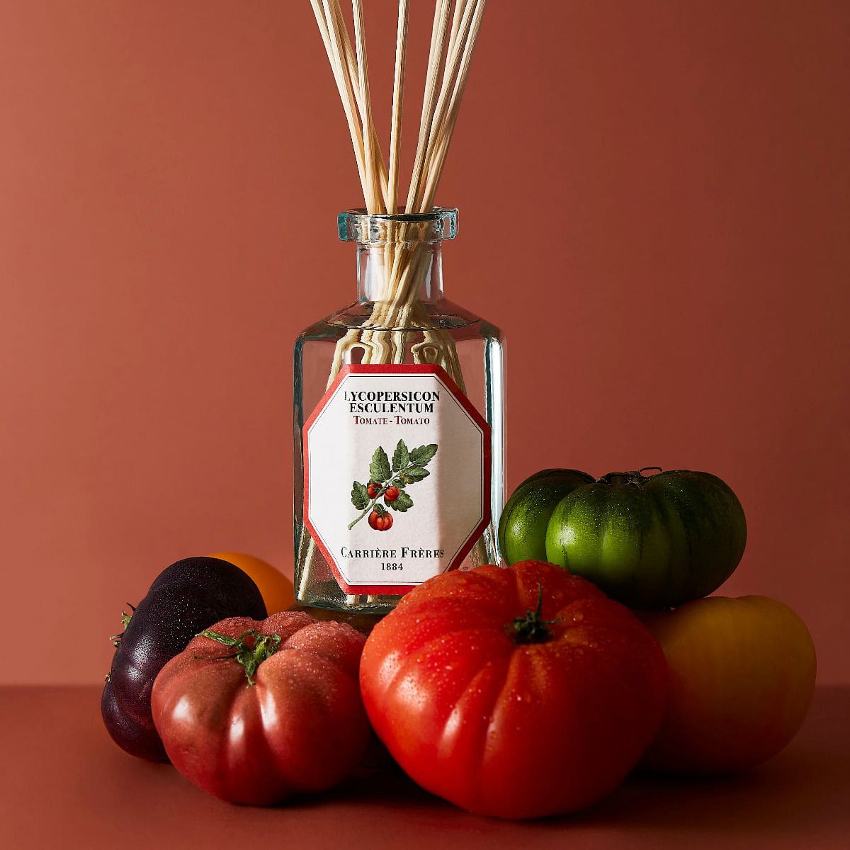 Lifestyle shot of Carriere Freres Tomato Diffuser (200 ml) with tomatoes surrounding diffuser