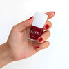 Close up of model wearing and holding bottle of Kure Bazaar Nail Lacquer - Sari (10 ml)
