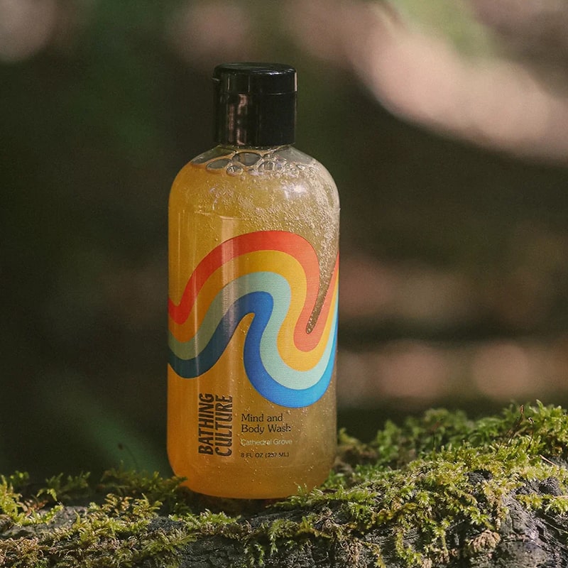 Lifestyle shot of Lifestyle shot of Bathing Culture Organic Mind and Body Wash Cathedral Grove (8 oz) with forest in the background