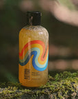 Lifestyle shot of Lifestyle shot of Bathing Culture Organic Mind and Body Wash Cathedral Grove (8 oz) with forest in the background