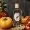 Lifestyle shot of Carriere Freres Tomato Room Spray (200 ml) with tomatoes in the foreground and background