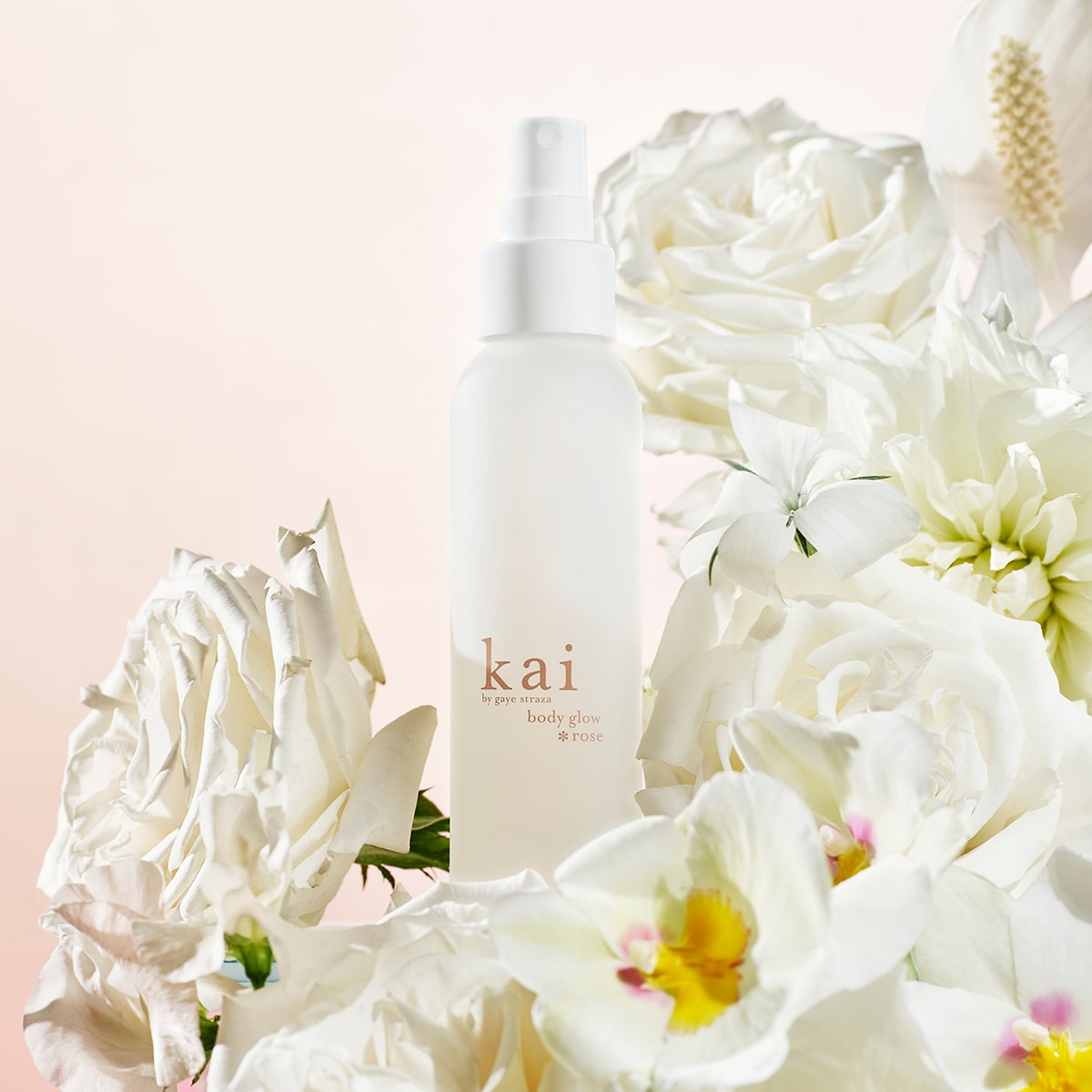 Kai Fragrance Rose Body Glow (4 oz) surrounded by white flowers on a light pink background