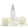 Kai Fragrance Rose Body Glow (4 oz) with two white roses on a white background