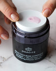 Close up of Odacite Bioactive Rose Gommage (50ml) with top off and rose grommage shown