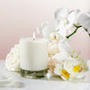 Kai Fragrance Rose Skylight Candle (10 oz) with white flowers on a light pink background