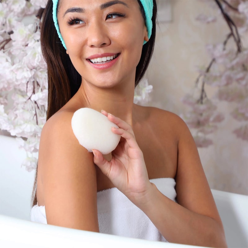 Daily Concepts Daily Konjac Sponge - model holding product in bath tub