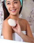 Daily Concepts Daily Konjac Sponge - model holding product in bath tub