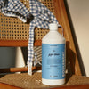 Kerzon Laundry Soap - Giga Doux (1 L) - product shown on wicker chair. 