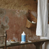 Kerzon Laundry Soap - Giga Doux (1 L) - product shown on wooden bench. 