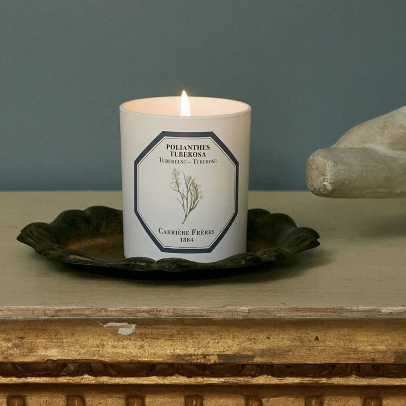 Lifestyle shot of Carriere Freres Tuberose Candle (185 g) shown lit on metal tray