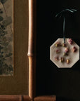 Lifestyle shot of Carriere Freres Damask Rose Botanical Palet hanging next to framed art