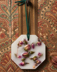 Lifestyle shot of Carriere Freres Damask Rose Botanical Palet hanging with ornate wallpaper in the background