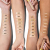 Kosas Cosmetics Revealer Concealer Super Creamy + Brightening Color Chart with color bars on model arms