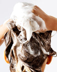 Model using Odacite 552M Shampoo Bar on hair