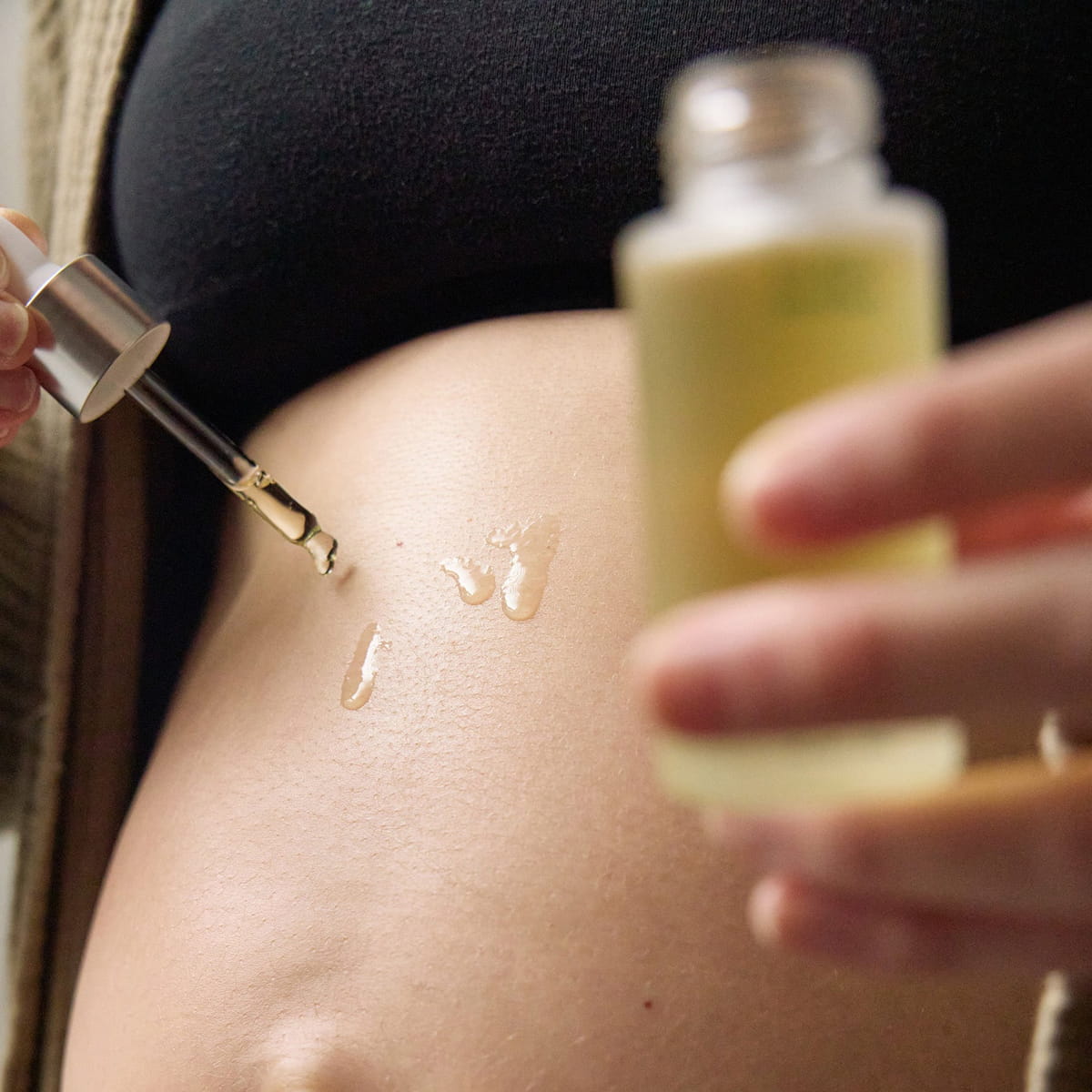 Mother Mother Everything Oil (1 oz) - product shown being applied to pregnant belly. 