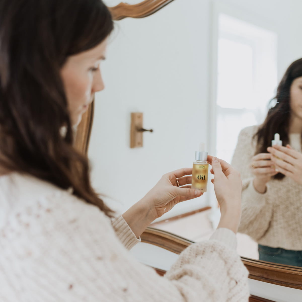 Mother Mother Everything Oil (1 oz) - product shown being held by model. 