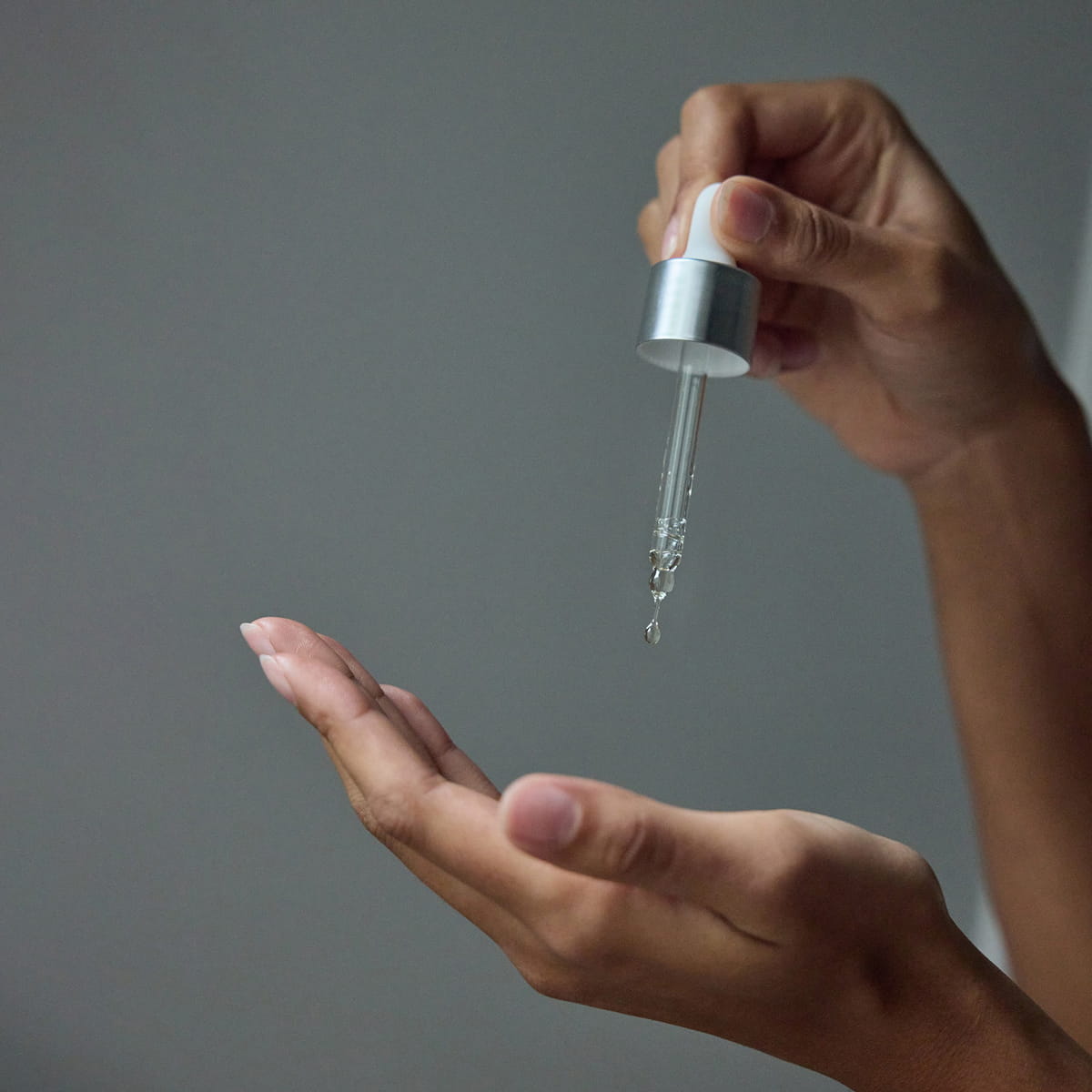 Mother Mother Everything Oil (1 oz) - product shown being dropped into hand. 