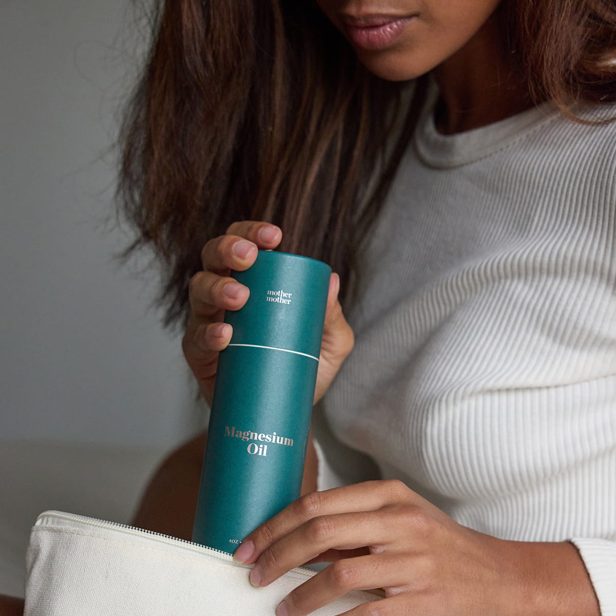 Mother Mother Magnesium Oil (4 oz) - product shown being held. 