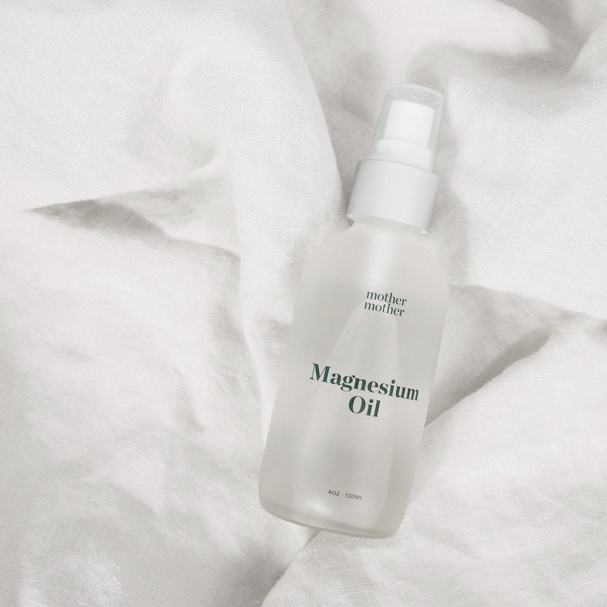 Mother Mother Magnesium Oil (4 oz) - product shown on white sheet. 