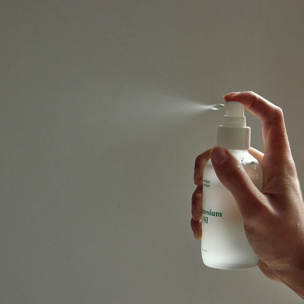 Mother Mother Magnesium Oil (4 oz) - product shown being sprayed. 