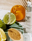 Lifestyle shot of Yon-Ka Paris Alpha Fluid (50 ml) with fruit in the foreground and background